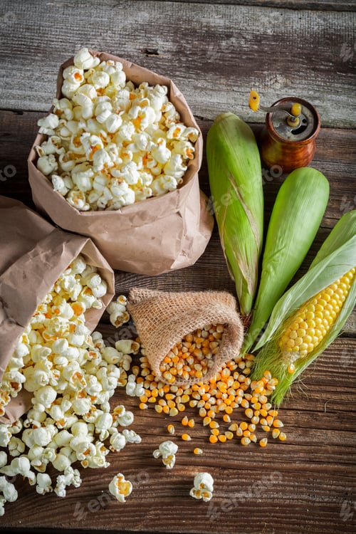Fresh Popcorn and Corn Kernels on Rustic Wood