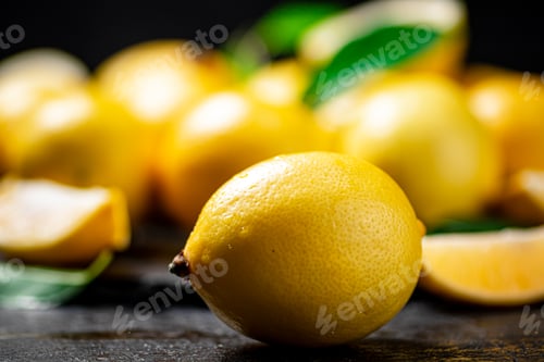Preview: Fragrant lemons with leaves on the table.