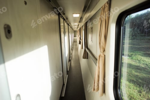 Preview: Narrow aisle inside the train with view of nature outside