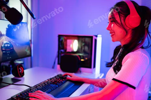 Preview: Asian beautiful Esport woman gamer play online video game on computer.