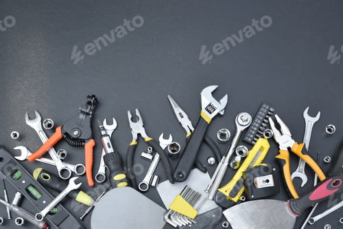 Preview: Handyman tool kit on black wooden table. Many wrenches and screwdrivers, pilers and other tools for