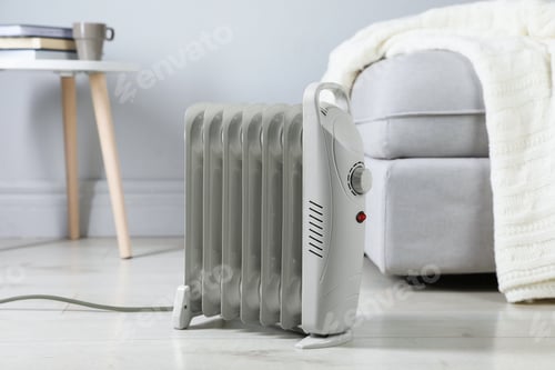 Preview: Electric heater on light wooden floor indoors