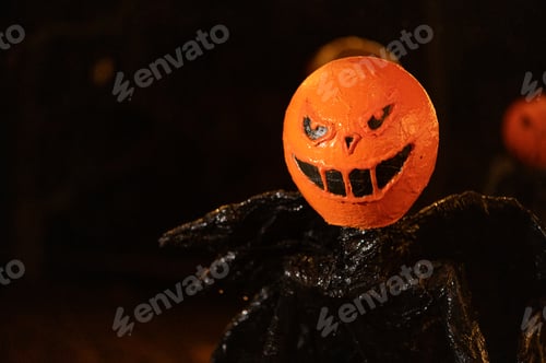 Preview: halloween monster with scary pumpkin face on dark night background