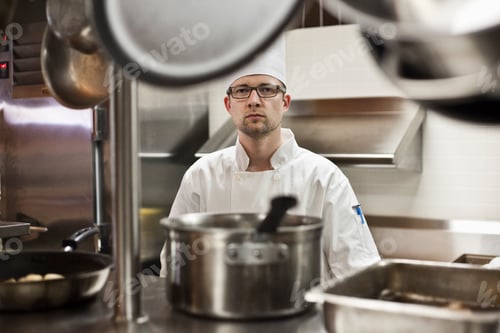 Preview: A portrait of a caucasian male chef in a commercial kitchen.