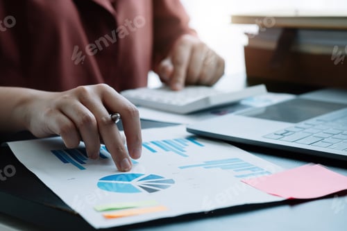 Preview: accountant working on desk using calculator for calculate finance report in office