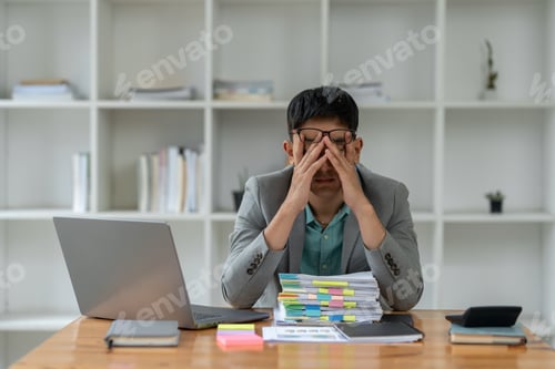 Preview: tired business man sleepy and bored from sitting at a desk for a long time and has office syndrome
