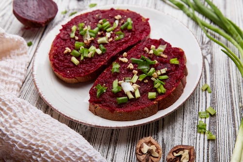 Preview: Beetroot spread with spring young onion and walnuts sandwiches. Vegetarian food close up