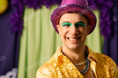 Preview: Portrait of a man dressed up for Mardi Gras festival looking at camera.