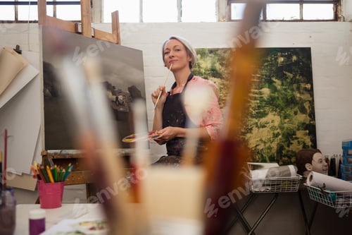Preview: Woman painting on canvas