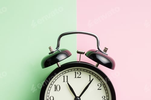 Preview: Vintage alarm clock on two tone color background.