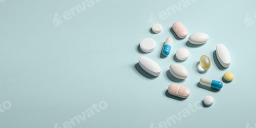 Preview: Assorted pills and capsules on pastel blue background with copy space create clean medical banner