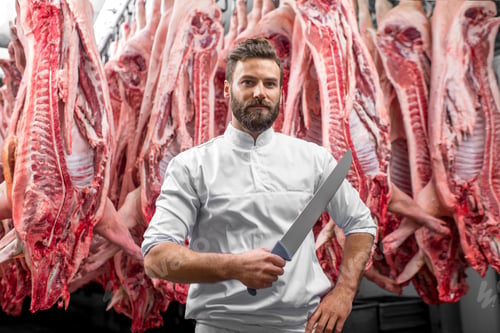 Preview: Portrait of a butcher at the meat manufacturing