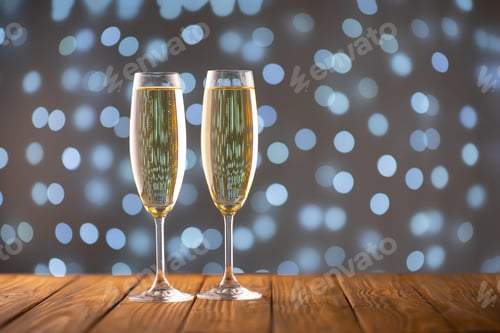 Preview: Two Wine Glasses With Bubbly Champagne On Blurry Sparkling Lights Background