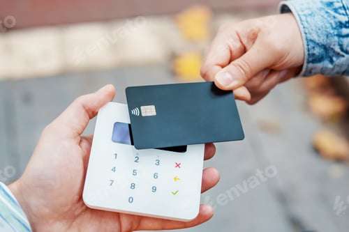 Preview: Crop customer paying with card and contactless terminal on street