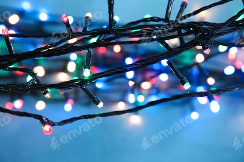 Preview: Beautiful Christmas lights on color background, closeup