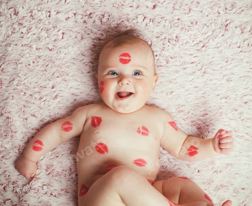 Preview: Newborn baby girl on the soft blanket filled kisses made with the lipstick.