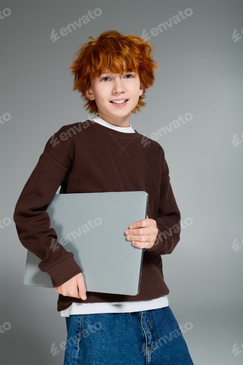 Preview: Redhead boy showcases stylish casual outfit in creative studio environment