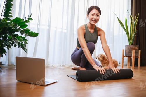 Preview: Woman Unrolling Yoga Mat at Home with Dog