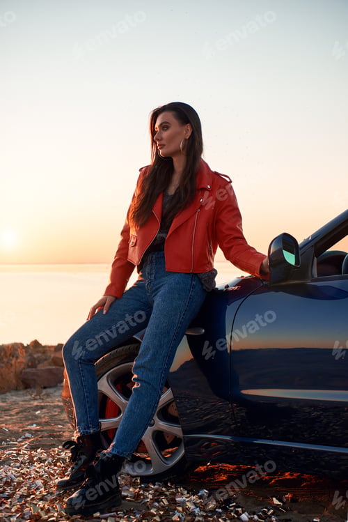Preview: Woman in red near cabriolet. She wearing sunglasses