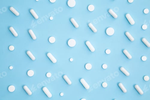 Preview: Various white medication tablets and capsules. Concept of healthcare and medicine. Top view, pattern