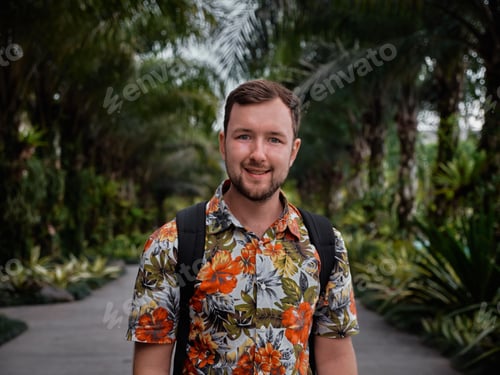 Preview: Caucasian man with a floral shirt posing with a walkway and palm trees in the background