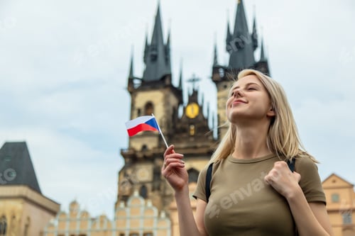 Preview: Blonde woman with a flag at central square in Prague, Czech Republic