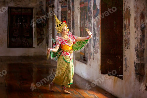 Preview: Portrait of Thailand dancer in Kinnaree costume dancing against the temple wall