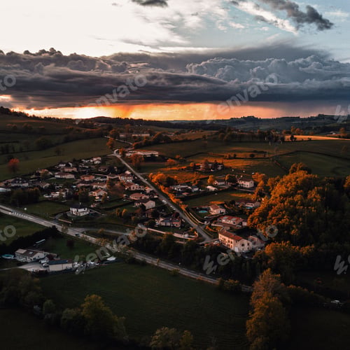 Preview: Aerial view of a village illuminated by the sunset