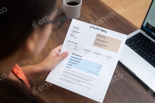 Preview: Woman holding utility bill, vividly capturing the essence of taxes and household costs