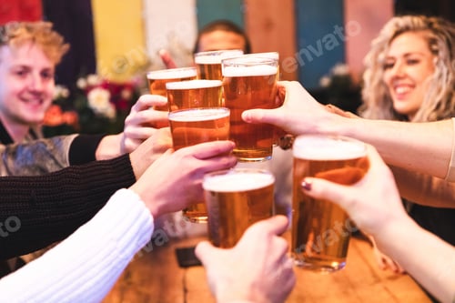 Preview: Friends drinking and toasting beer at pub