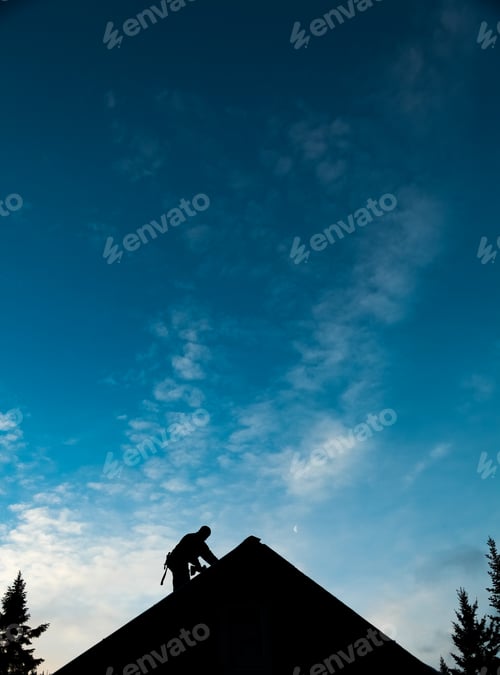 Preview: Contractor in Silhouette working on a Roof Top