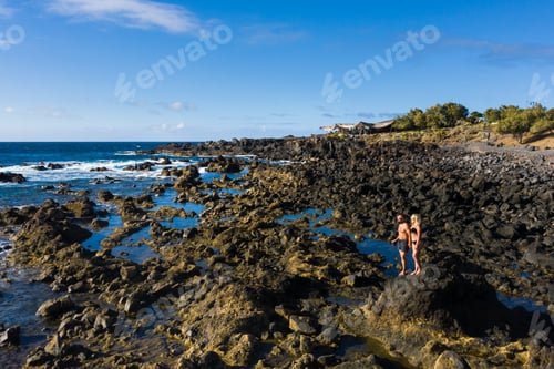 Preview: The couple stands on Rough rock formations near the ocean on the island of Tenerife.The Canary