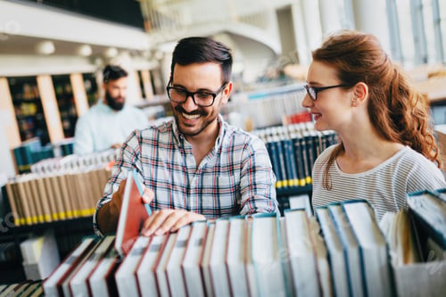 Preview: Young attractive students spending time in library