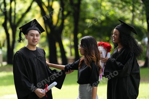 Preview: graduates in caps and gowns beam with joy, embracing and cheering in celebration.