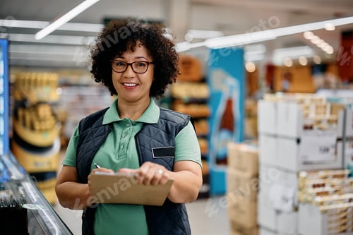Preview: Happy quality control manager working in supermarket and looking at camera.