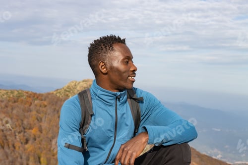 Preview: Young man on top of a happy mountain.