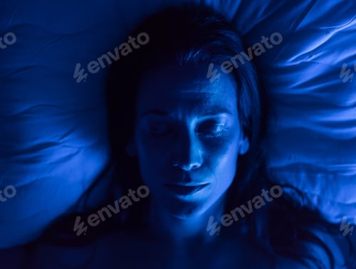 Preview: Close-up of woman sleeping in bed at night