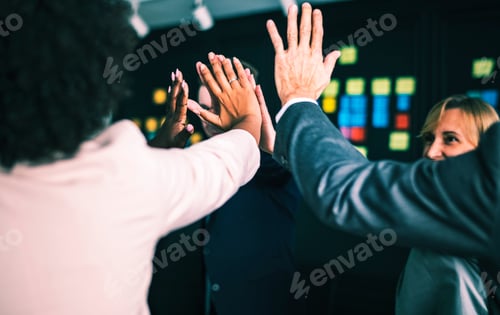 Preview: Business team giving a high five