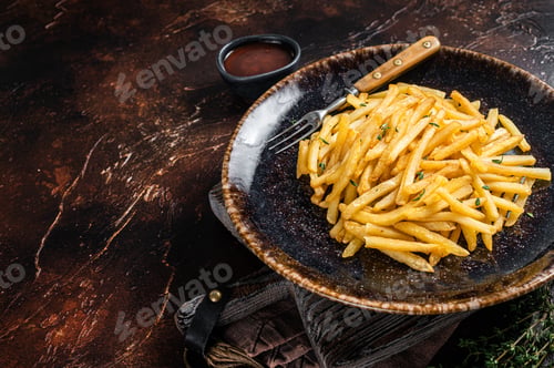 Preview: Homemade Baked Potato french fries in rustic palte with thyme. Dark background. Top view. Copy space