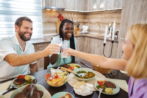 Preview: Friends dining happily in a cozy kitchen