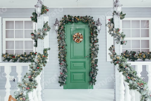 Preview: Green door entrance to the house. Christmas festive deco decorated with Christmas tree branches