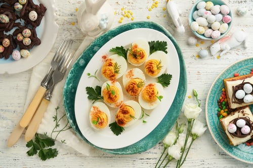 Preview: Traditional Easter brunch or dinner with stuffed eggs with paprika, carrot cake bars and chocolate n