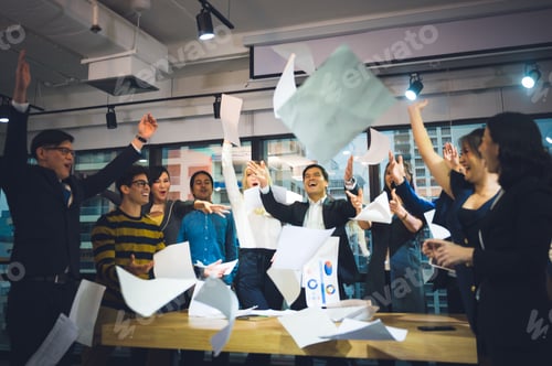 Preview: Group of business people rejoicing in closing the quarter successfully tossing up paper documents