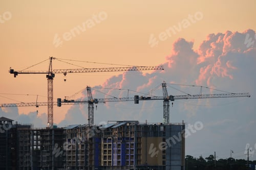 Preview: Tower lifting cranes at high residential apartment buildings construction site.