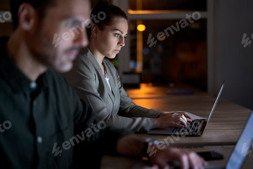 Preview: Caucasian workers working late at the office