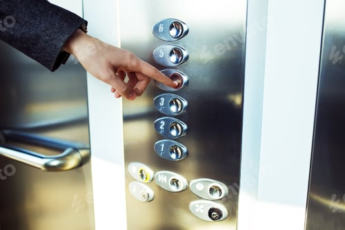Preview: Man pressing elevator button. finger presses the elevator button. Red button. sunset light.