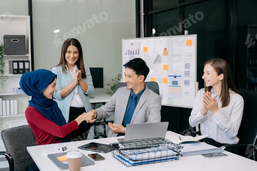 Preview: Happy businesspeople while collaborating on a new project in an office.
