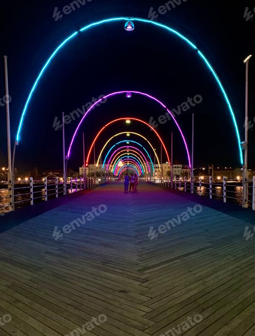 Preview: Vibrant Illuminated Bridge at Night with Walking People