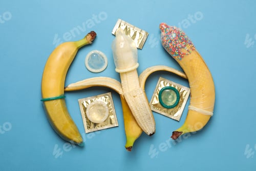 Preview: Condoms on bananas on a blue background