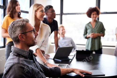 Preview: Creative business colleagues listening at a brainstorm meeting, close up